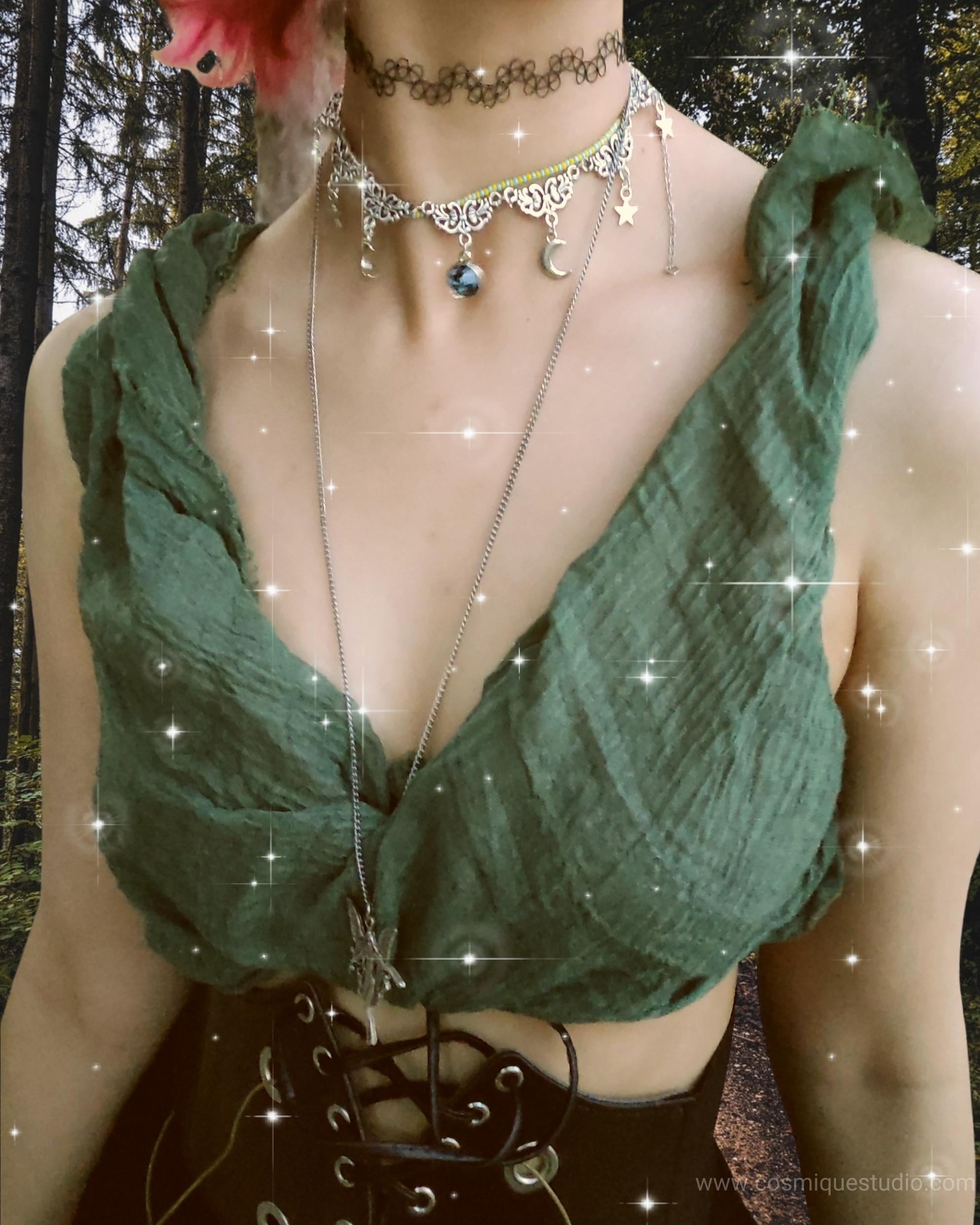 A fairy grunge aesthetic woman wearing chokers and a necklace. 