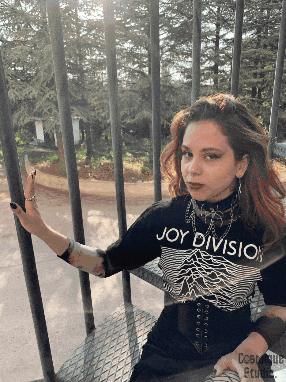 gif of a grunge girl on fire escape wearing joy division band t-shirt over animal print tulle blouse combined with black leather choker